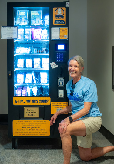 Candace Carson next to the WellPAC vending machine