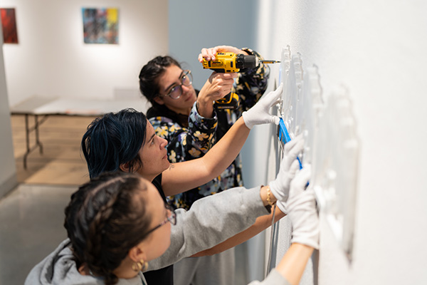 Art students installing a gallery