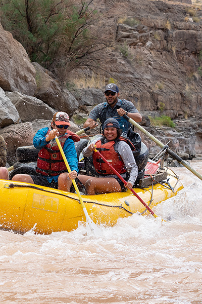 FLC FLOW guide leads a raft down a desert river